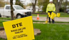 Photo of lawn marked with yellow flags indicating underground gas lines