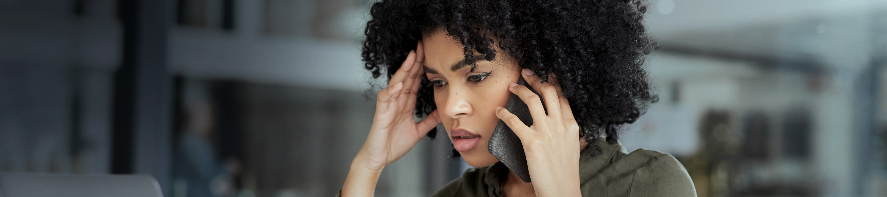 woman answers phone concerned expression